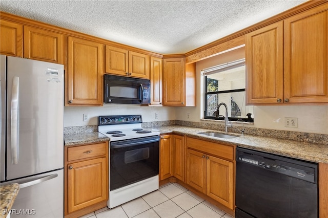 kitchen with light stone countertops, sink, a textured ceiling, light tile patterned floors, and black appliances