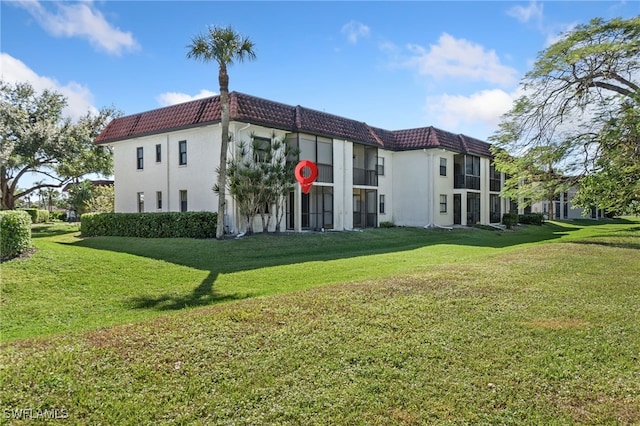 view of side of property with a yard