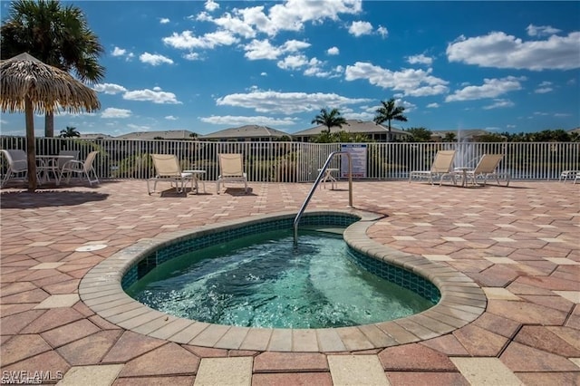 view of pool featuring a patio area and a hot tub