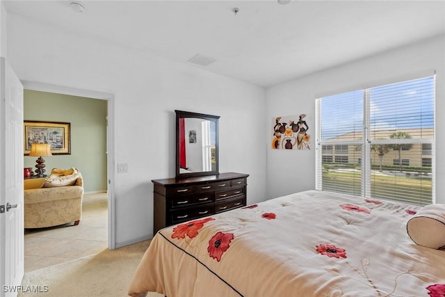 bedroom with light carpet, baseboards, and visible vents