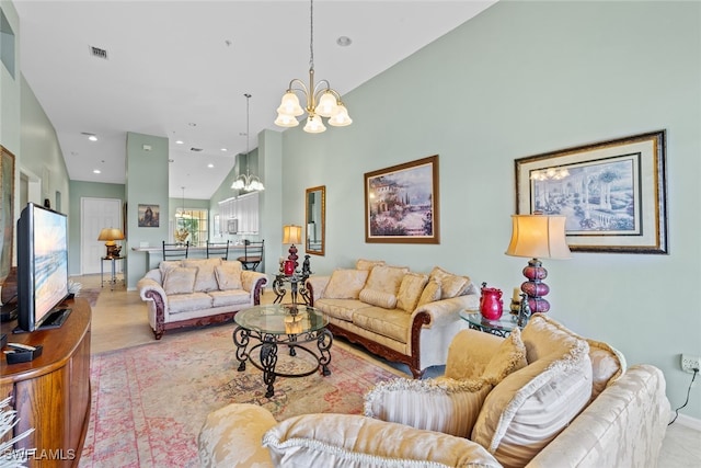 living room featuring high vaulted ceiling and a chandelier