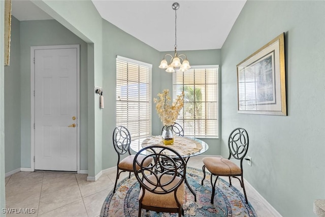 dining space featuring an inviting chandelier, light tile patterned floors, and baseboards