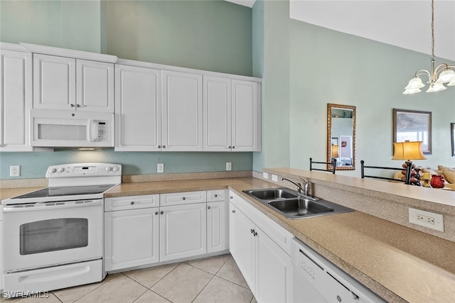 kitchen featuring sink, white cabinets, decorative light fixtures, and white appliances