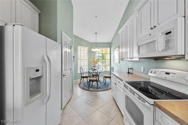 kitchen featuring white appliances, white cabinetry, hanging light fixtures, an inviting chandelier, and light tile patterned floors