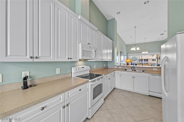 kitchen featuring sink, white cabinets, hanging light fixtures, and white appliances