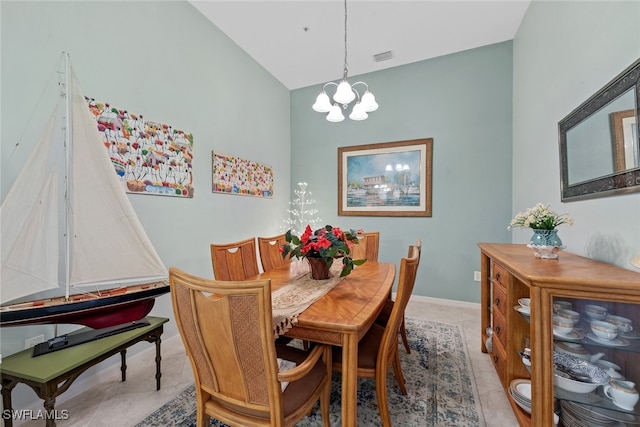 dining space featuring lofted ceiling and an inviting chandelier