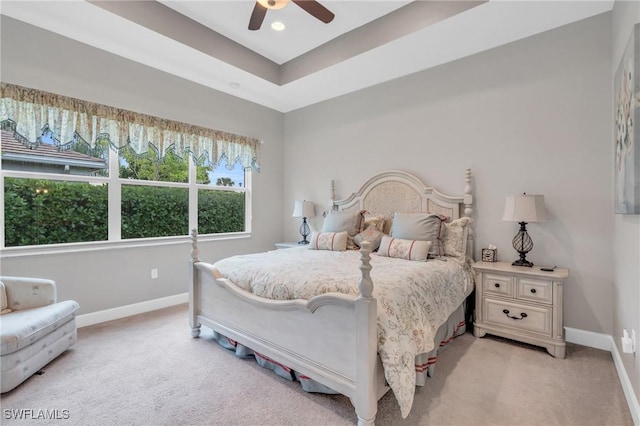 bedroom featuring ceiling fan, baseboards, and light colored carpet