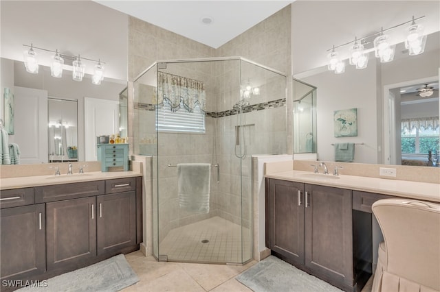 bathroom featuring tile patterned flooring, vanity, and walk in shower