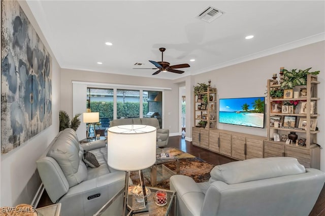 living area featuring recessed lighting, wood finished floors, visible vents, and crown molding