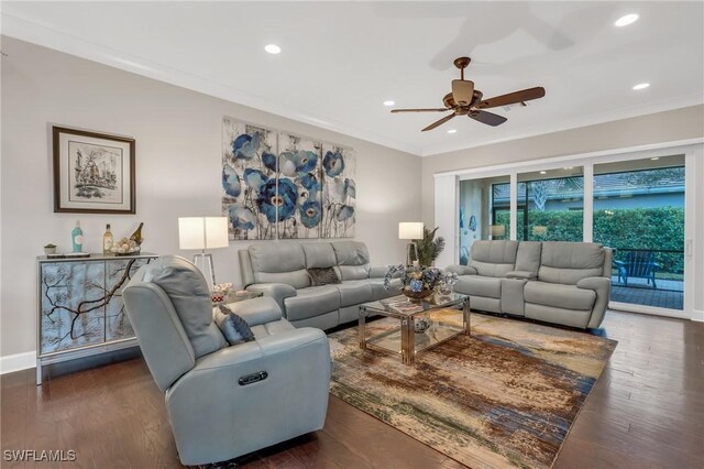 living room with crown molding, ceiling fan, and dark wood-type flooring