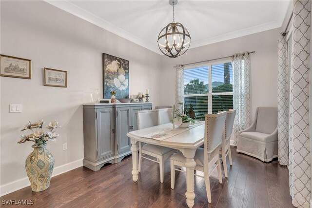 dining area featuring dark hardwood / wood-style floors, ornamental molding, and a notable chandelier