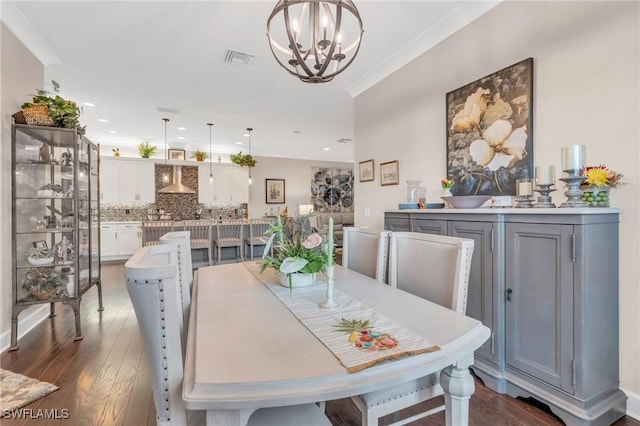 dining area with recessed lighting, visible vents, ornamental molding, dark wood-type flooring, and a chandelier