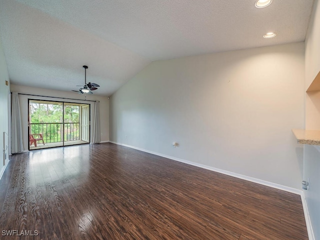 unfurnished living room with ceiling fan, dark hardwood / wood-style flooring, lofted ceiling, and a textured ceiling