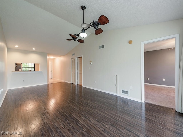 unfurnished living room with a textured ceiling, dark hardwood / wood-style floors, ceiling fan, and lofted ceiling