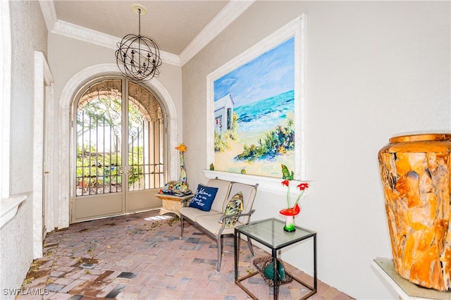 interior space featuring an inviting chandelier and ornamental molding