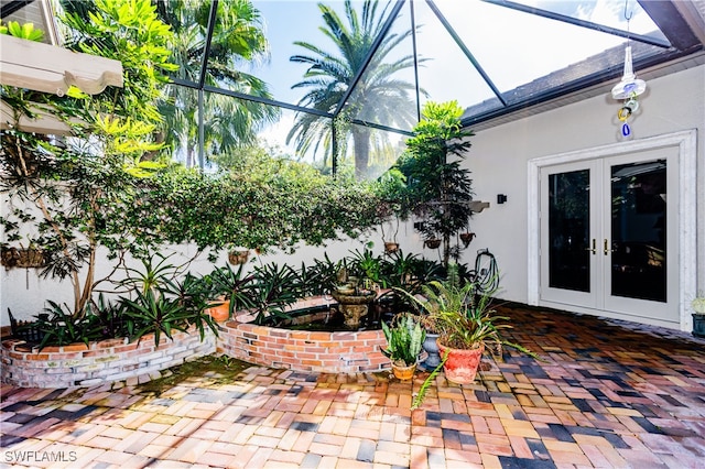 view of patio with french doors and a lanai