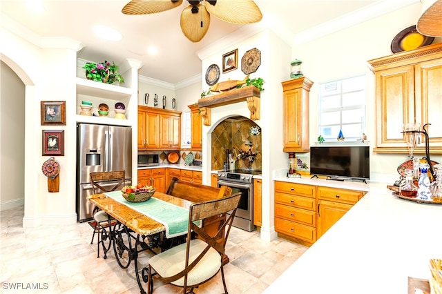 kitchen with ceiling fan, stainless steel appliances, and ornamental molding