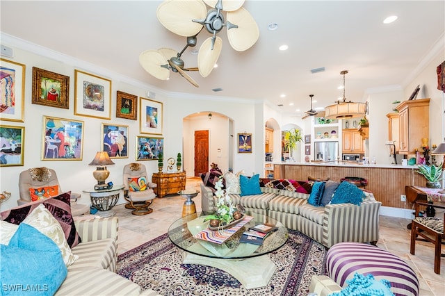 tiled living room featuring ceiling fan and ornamental molding