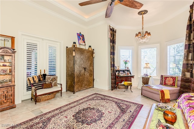 sitting room featuring ceiling fan with notable chandelier and crown molding