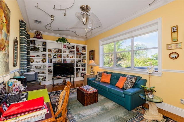 living room featuring hardwood / wood-style floors and crown molding