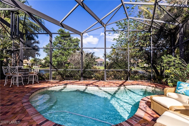 view of swimming pool with a patio area and glass enclosure