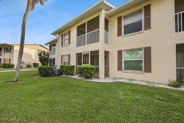 exterior space featuring a yard and central AC unit