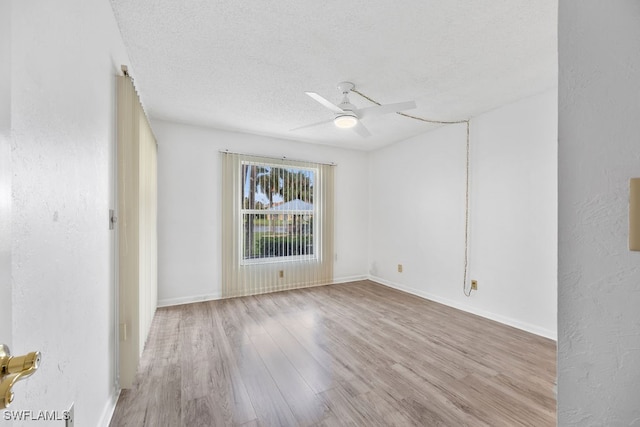 unfurnished room with light hardwood / wood-style flooring, ceiling fan, and a textured ceiling