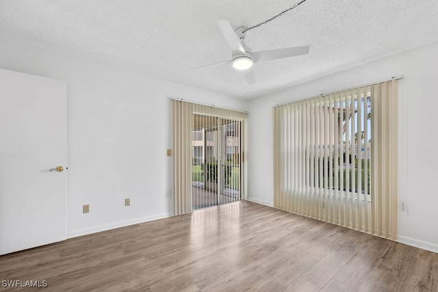 unfurnished room featuring light hardwood / wood-style flooring, ceiling fan, and a textured ceiling