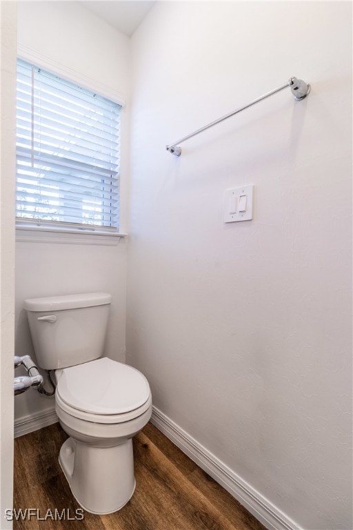 bathroom with toilet and hardwood / wood-style floors