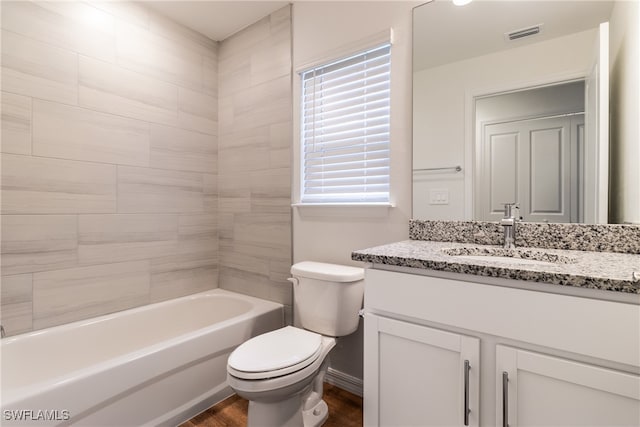 full bathroom featuring hardwood / wood-style floors, vanity, toilet, and shower / bathtub combination