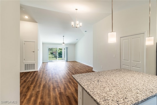 interior space with dark wood-type flooring, high vaulted ceiling, and ceiling fan with notable chandelier