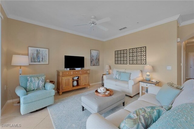 tiled living room featuring ceiling fan and ornamental molding