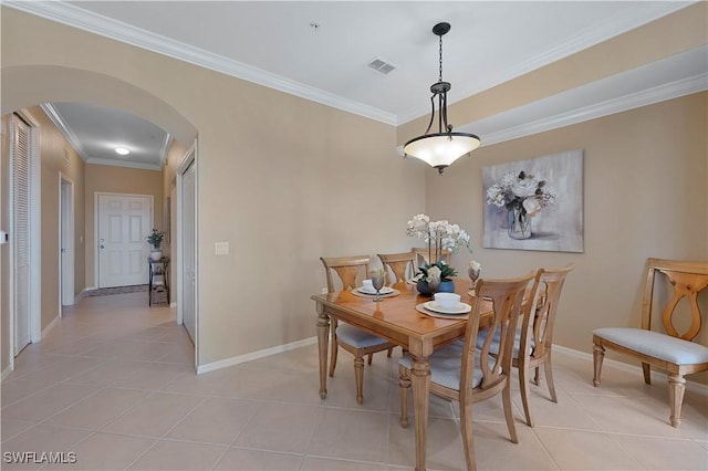 tiled dining room with ornamental molding