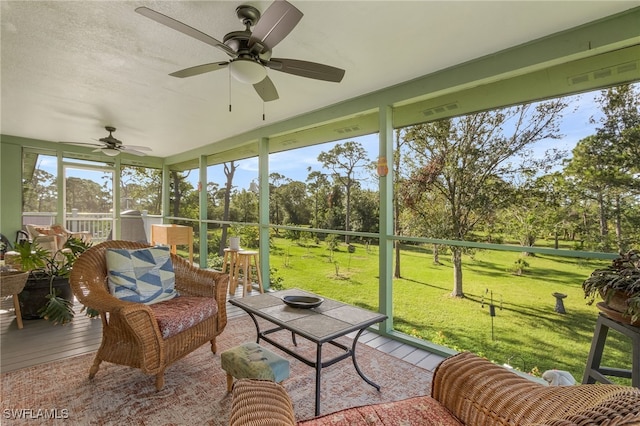 sunroom featuring ceiling fan