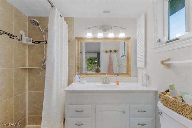 bathroom featuring vanity, toilet, and curtained shower