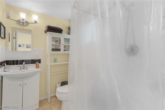 bathroom featuring decorative backsplash, vanity, tile patterned floors, and toilet