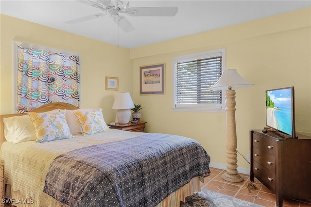 bedroom with ceiling fan and light tile patterned floors