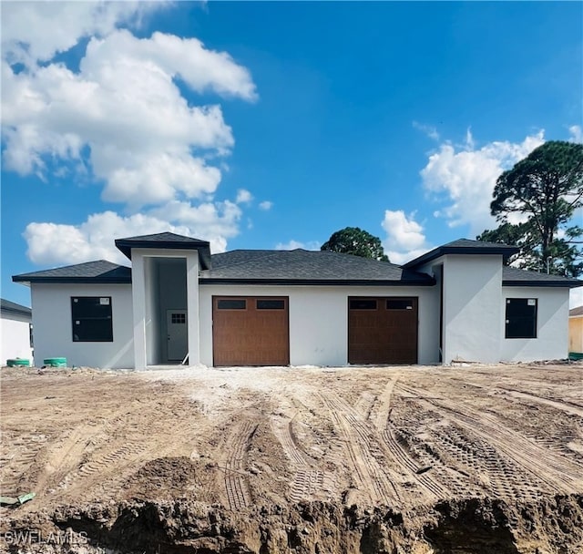 prairie-style home featuring a garage