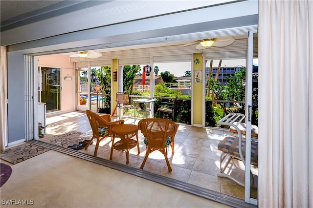 sunroom / solarium with ceiling fan