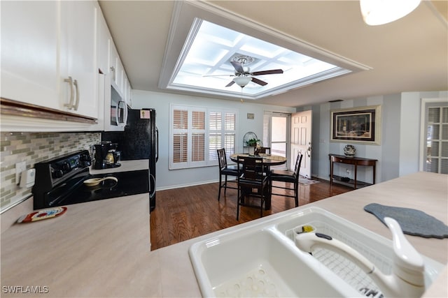 kitchen with white cabinets, sink, ceiling fan, black / electric stove, and dark hardwood / wood-style flooring