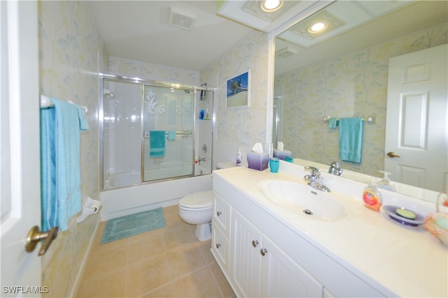 full bathroom with tile patterned flooring, vanity, toilet, and enclosed tub / shower combo