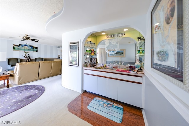 bar with carpet flooring, ceiling fan, and sink