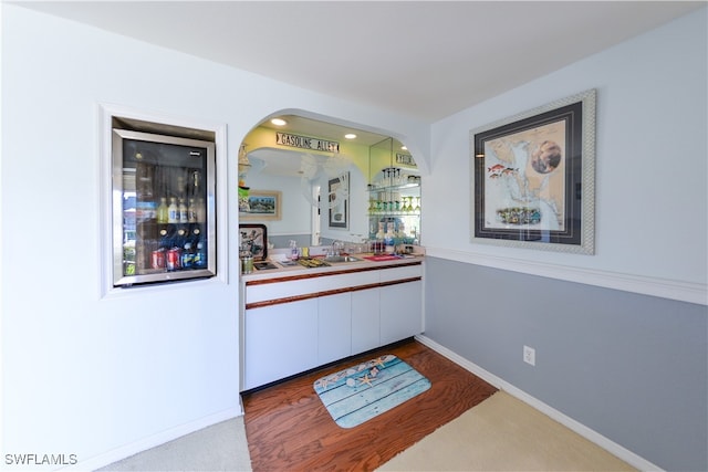 bar featuring carpet floors and sink