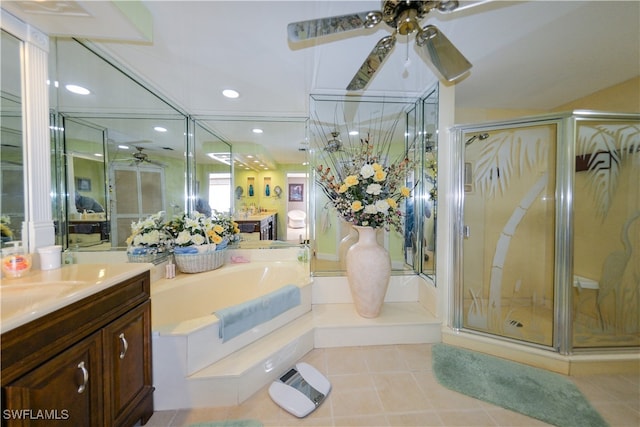 bathroom featuring tile patterned flooring, shower with separate bathtub, and vanity