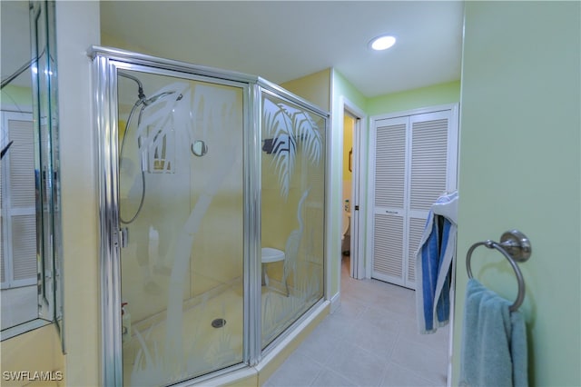 bathroom featuring tile patterned floors and a shower with door