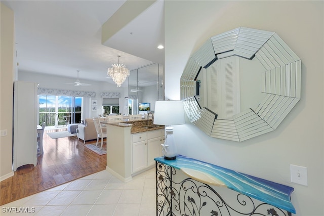 interior space featuring sink, an inviting chandelier, and hardwood / wood-style flooring