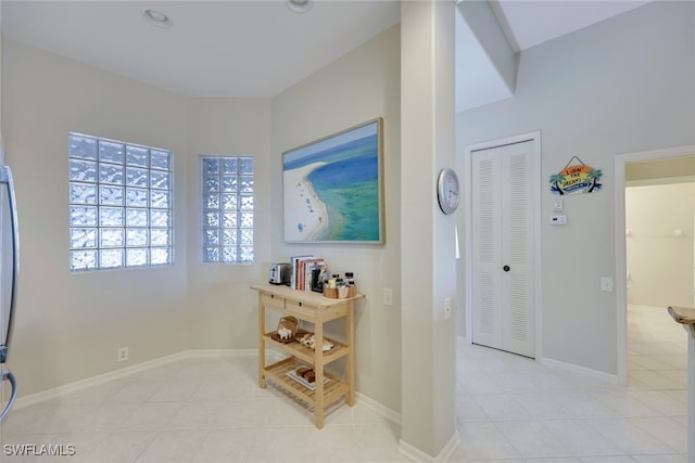 hall with light tile patterned floors