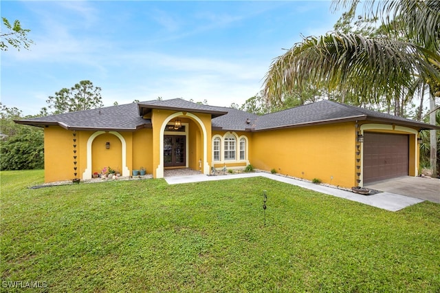 view of front of home featuring a garage, french doors, and a front yard