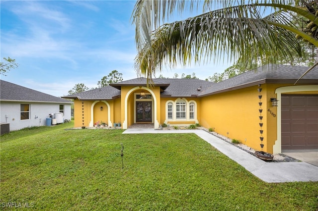 ranch-style home featuring a garage and a front lawn