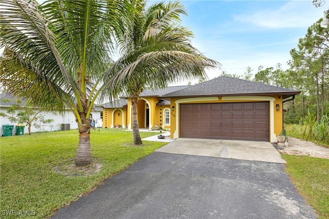 view of front of property featuring a garage and a front lawn